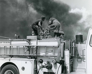 Two men on top of fire truck