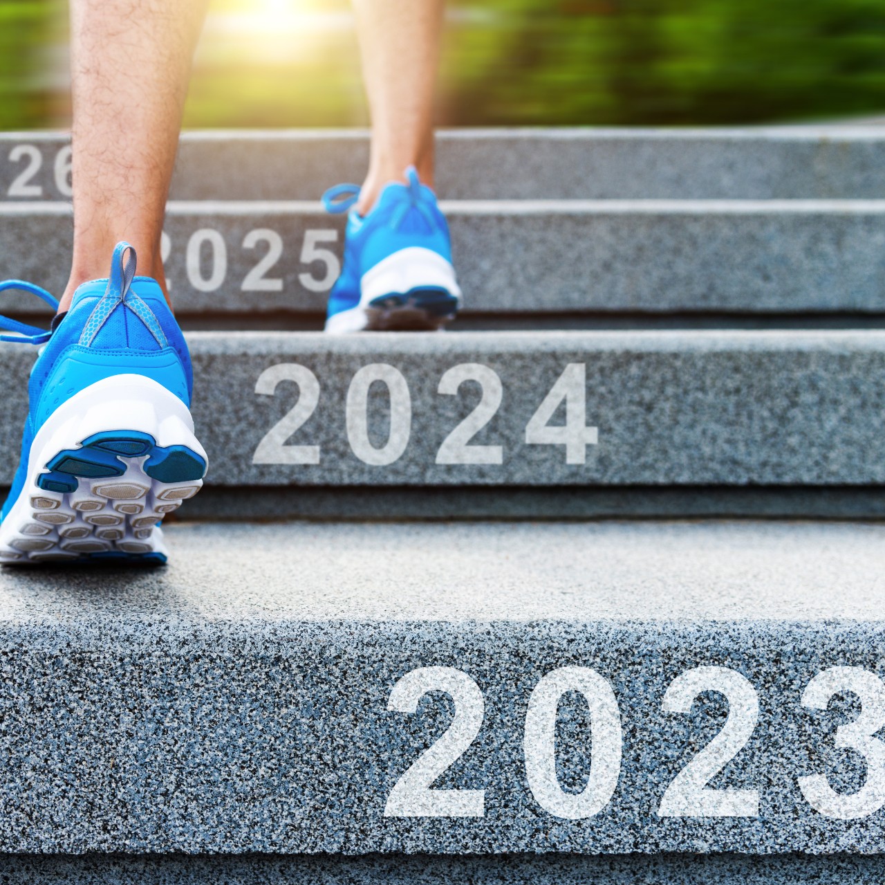 person in blue sneakers climbing stairs labeled 2023 to 2024