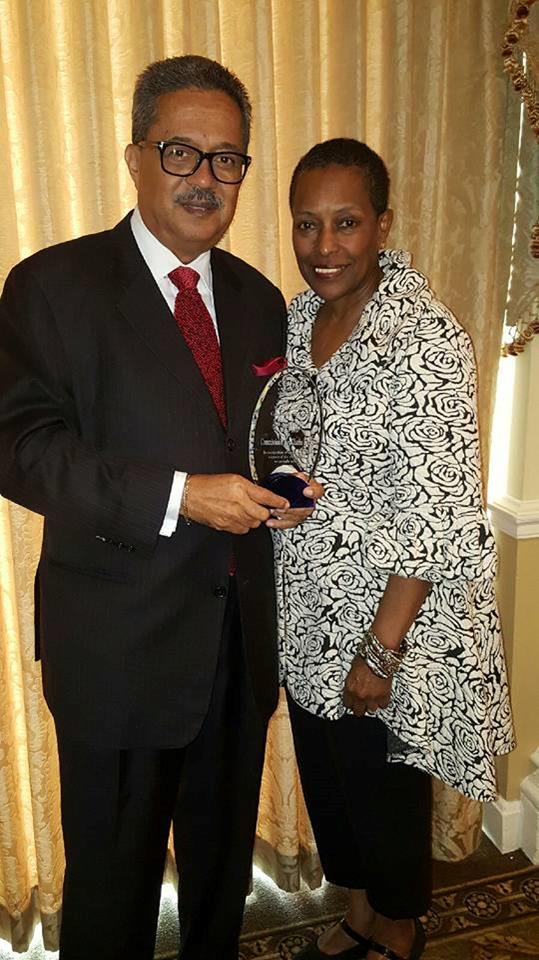 Commissioner and Dr. Brooks posing with award