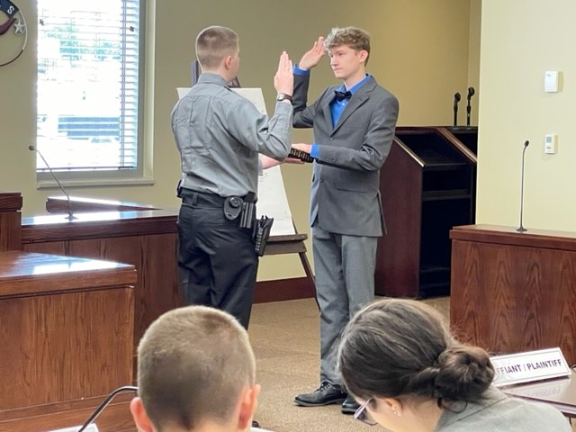STUDENT PLAINTIFF GETTING SWORN IN BY A STUDENT BAILIFF