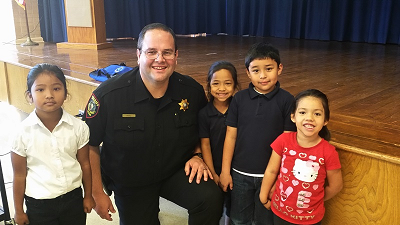 Community Relations Sergeant with students